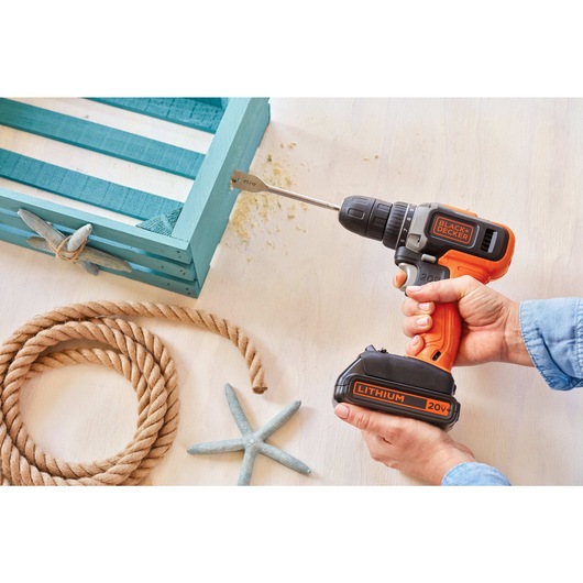 2 Speed Cordless Drill Driver with 2 Batteries being used to drill into wood frame.