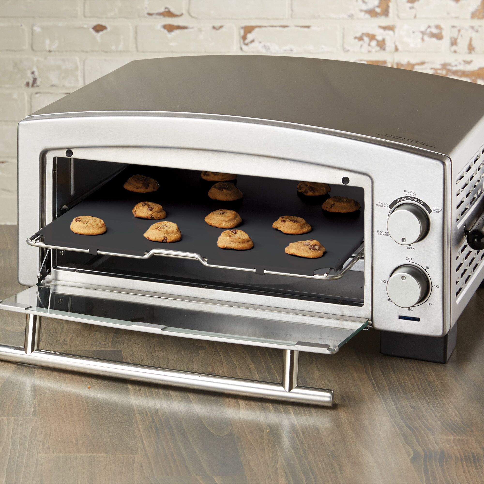 A tray of baked cookies inside 5 minute pizza oven and snack maker.
