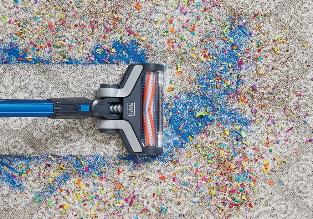 POWER SERIES Extreme Cordless Stick Vacuum Cleaner being used for cleaning mess from carpet.